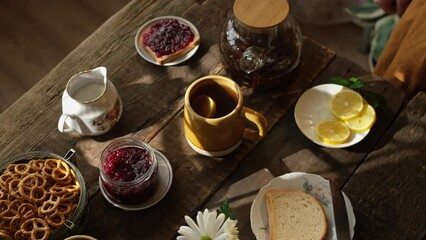 Wall Mural - Woman drinking tea with lemon during morning breakfast.