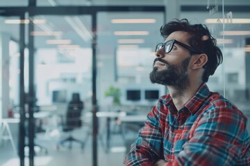 Poster - A blurred professional stands confidently in a modern, stylishly designed office space with large windows