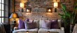 Interior design featuring a brick wall with purple accents on pillows and lamps.
