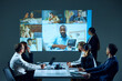 © master1305 - Education courses launching. Workers in office setting engage in virtual meeting, with coworkers from different locations. Concept of business, entrepreneurship, communication, teamwork