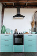 Stylish kitchen interior, blue cabinet furniture, gas stove and kitchenware