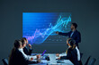 © master1305 - Team members sitting in boardroom setting, reviewing digital stock chart on screen as part of a business discussion. Financial investment. Concept of business, trade market, economics, finances