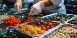 Fototapeta Młodzieżowe -  A chef in white gloves is serving food from the large stainless steel bin with fresh and colorful vegetables, mushrooms or steaks on top to guests at luxury restaurant 