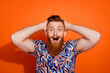 Photo of excited funky guy dressed print shirt arms head open mouth isolated orange color background