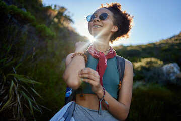 Wall Mural - travel, sunshine and woman with sunglasses in nature for hiking in morning, adventure or explore out