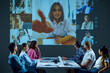 © master1305 - Colleagues in office conference room connect with remote team members via video conference, discussing project priorities and strategies. Concept of business, entrepreneurship, communication, teamwork
