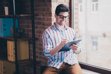 Sticker - Photo of nice young corporate man pen write clipboard wear striped shirt loft interior office indoors