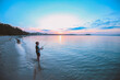 © Austockphoto - Young boy fishing on the beach at sunset