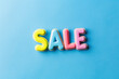 The word sale spelled out in vibrant and colorful letters against a solid blue background