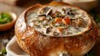 A hearty bowl of creamy clam chowder served in a bread bowl, representing the comforting and soul-warming soups of Western culinary tradition.