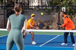 © Mat Hayward - An active pickleball game happening on an outdoor court. The group of players are highly competitive in the popular sport.