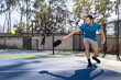 © Mat Hayward - Pickleball players in a game on an outdoor court