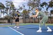 © Mat Hayward - Co-ed pickleball team. The players are active on the court for a fun and fast game.