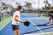 © Mat Hayward - Pickelball players in a competitive match on an outdoor court. The game is fun and exciting.