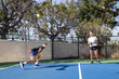 © Mat Hayward - Pickelball players in a competitive match on an outdoor court. The game is fun and exciting.