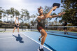 © Mat Hayward - Pickleball game happening on an outdoor court. The players are having fun with the popular sport.