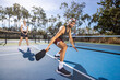 © Mat Hayward - Pickleball game happening on an outdoor court. The players are having fun with the popular sport.