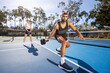 © Mat Hayward - Pickleball game happening on an outdoor court. The players are having fun with the popular sport.