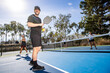 © Mat Hayward - Pickleball player on an outdoor court in the summer. The popular sport is fun and excellent exercise.
