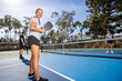 © Mat Hayward - Pickleball player looking back and smiling during a game.