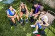 © Mat Hayward - A group of four friends sit in the shade and rest after a pickleball match on an outdoor court.