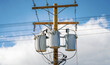 Electric pole with a three distribution transformers in Canada