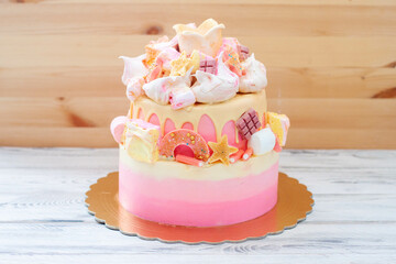 Wall Mural - Gradient layered pink birthday cake with meringue clouds, chocolate stars, donuts and golden fondant crown for a little princess
