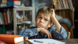 © Nemanja - Stressed young pupil student, exhausted and frustrated preschool boy sitting at a desk or table in his room. Reading notebooks, homework deadline, toddler kid or child, studying for exam