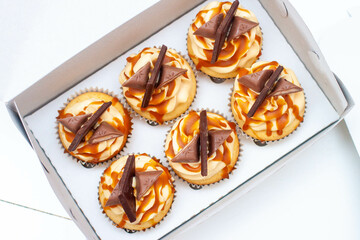Wall Mural - Homemade butterscotch cupcakes with caramel syrup and cream cheese frosting