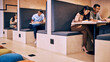 © peopleimages.com - People, coworking and cubicle at startup office with teamwork, writing and discussion at media agency. Men, women and together in workplace with creativity with notebook, collaboration and research