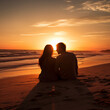 Romantic couple sitting on beach at sunset