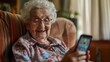 Happy senior female holding smartphone using mobile phone app. Technology, communication, happy adult woman with smartphone at home, recreation, communication, sociality, hobbies, adaptation