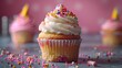 A playful birthday cupcake decorated with sprinkles, candy, and a mini party hat, 4k, ultra hd