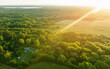 Rural landscape, aerial view. Country houses in countryside. Village Home in Country on sunset. Wooden house in Russian village, drone view. Rural house in forest. Roofs of village home in sunrise.