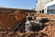 `Storm sewer pipes laying. Building construction on Construction site. Water main and sanitary sewer pipes, well. Ground water drainage system pipes. Groundwork for sewer construction, Sewerage.