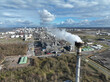 Aerial drone view of a smokestack causing industrial pollution and symbolizing greenhouse gases and climate change.