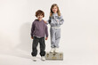 © New Africa - Fashion concept. Stylish children with vintage suitcase on white background
