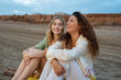 © Milles Studio/Stocksy - Girls having funny conversation at beach