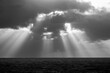 © James Fulton/Stocksy - Dramatic light rays on the ocean at sunset