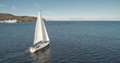 Closeup slow motion of sail boat at ocean gulf aerial. Racing yacht at sea bay. Majestic seascape at luxury sailboat at Brodick pier, Arran island shore, Scotland, Europe. Cinematic summer cruise