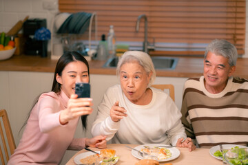 Wall Mural - Asian Family Happiness in the Kitchen: Senior Parents Cooking Dinner with Joy, Children Laughing, A Fun and Loving Atmosphere of Togetherness, Creating Delicious Meals and Beautiful Memories