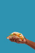 © RZCREATIVE/Stocksy - Hand holding shrimp taco with copy space.