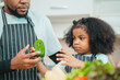 © chokniti - Smiling African-American father shares fun and love with his cheerful children at home, celebrating family with childhood together, African American black person in happy together of father's day