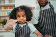 © chokniti - In a home kitchen, black father and his daughter bond over cooking a meal food, their laughter and love filling the air, embodying the joy of African American family life, Father's Day concept