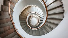 A Spiral Staircase Winding Upwards, Symbolizing The Journey Of Aspiration, Challenges, Progress, And The Achievement Of Goals
