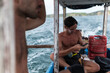 © Manu Prats/Stocksy - Traveller man using smartphone in a boat