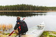 © Diego Martin/Stocksy - Relaxed man sitting in kayak in wilderness adventure