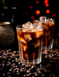 A glass of black iced coffee on dark background with copy space