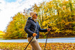 Mid-adult woman exercising nordic walking in city park
