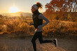 © BONNINSTUDIO/Stocksy - Woman running in countryside at sunrise